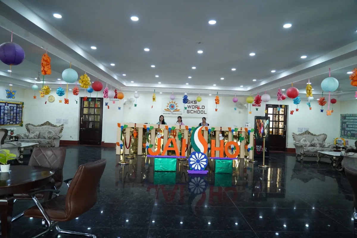 Reception desk with staff in front of the SKS World School logo