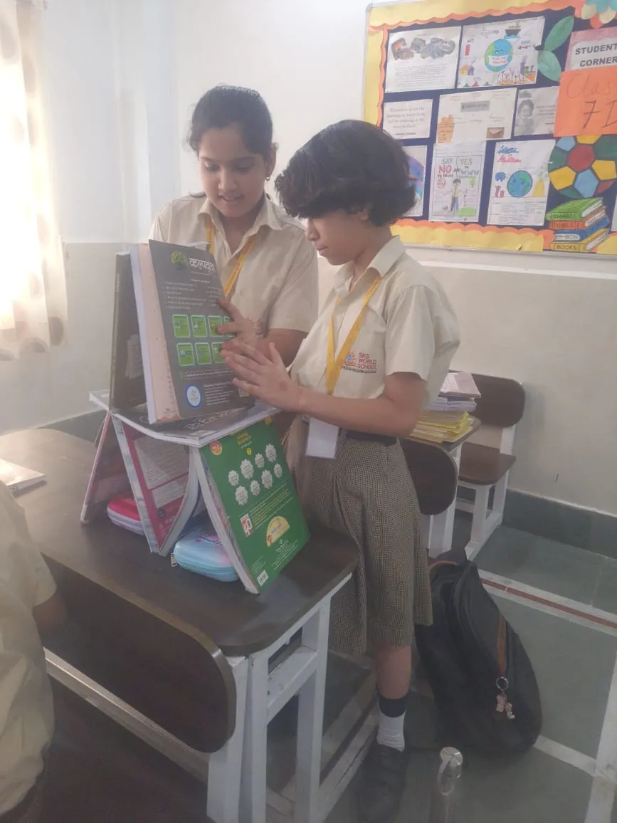 Students building a structure from books in a class activity at SKS World School, Greater Noida West