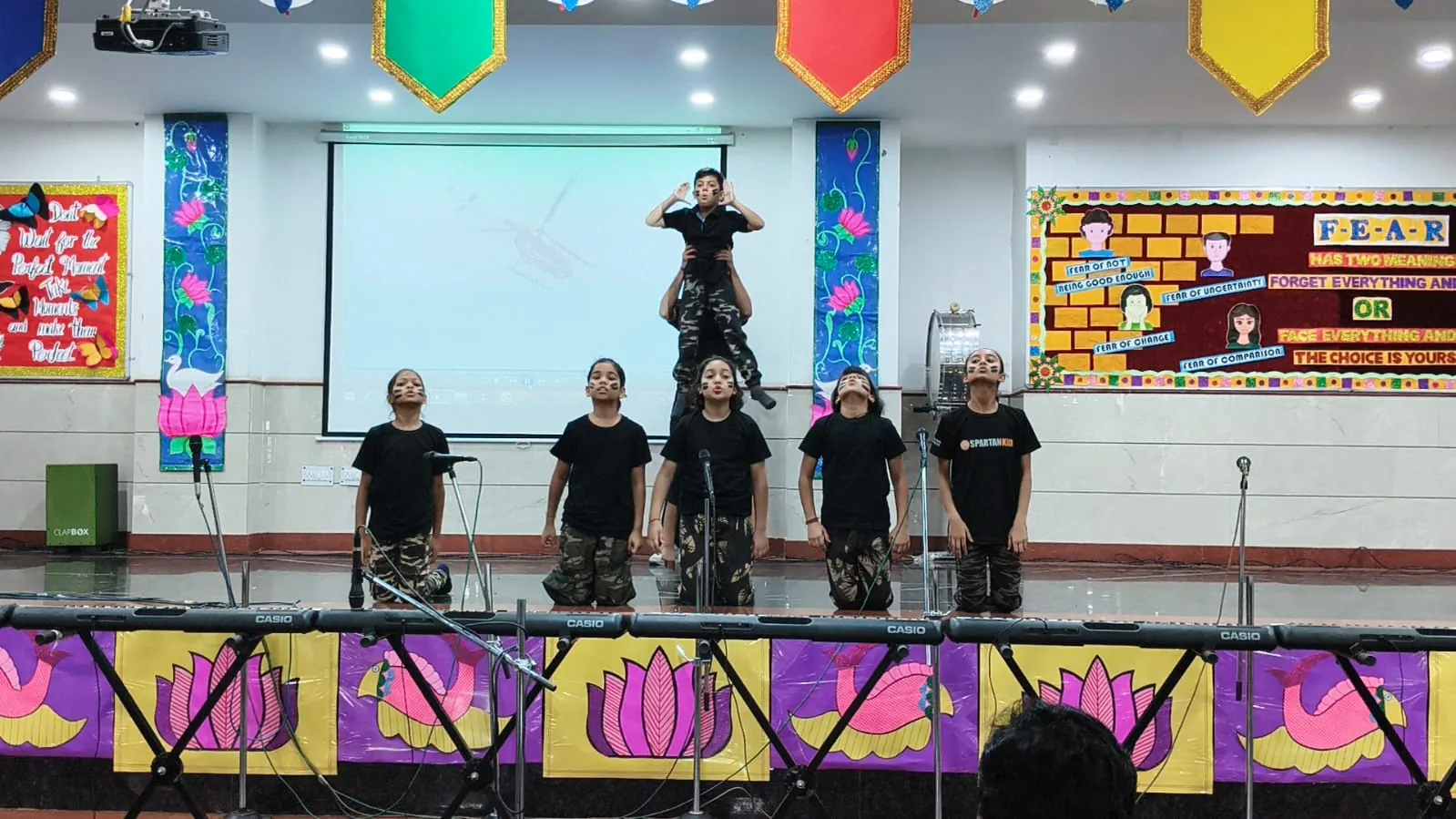 Students performing an army-themed dance on stage at SKS World School, Greater Noida West