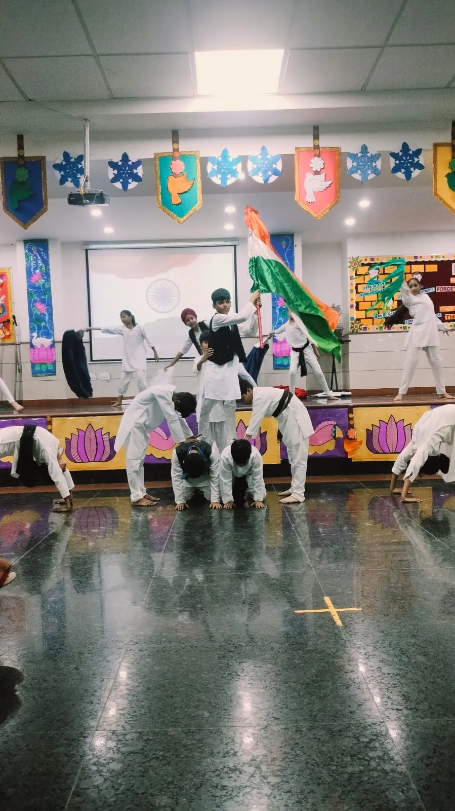 Student waving the national flag during an Independence Day dance at SKS World School, Greater Noida West