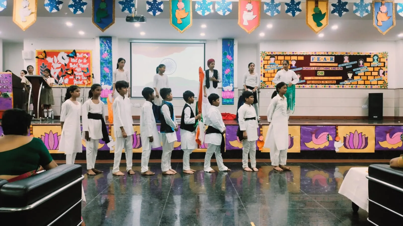 Students in white kurtas performing an Independence Day act at SKS World School, Greater Noida West