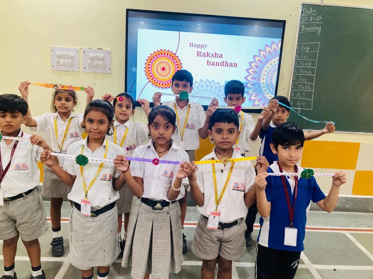 Primary students holding their handmade rakhis at SKS World School, Greater Noida West