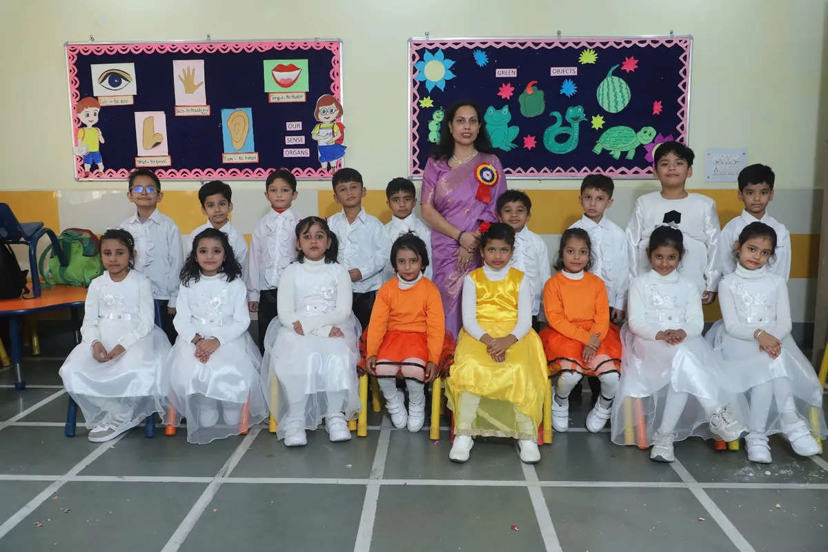 Pre-primary students in Annual Day costumes with their class teacher at SKS World School, Greater Noida West