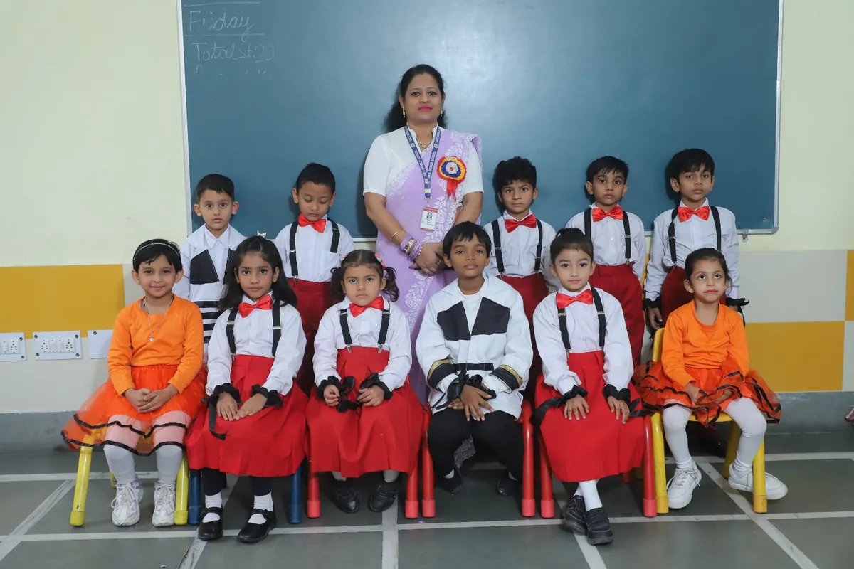 Primary class in Annual Day costumes with their teacher at SKS World School, Greater Noida West