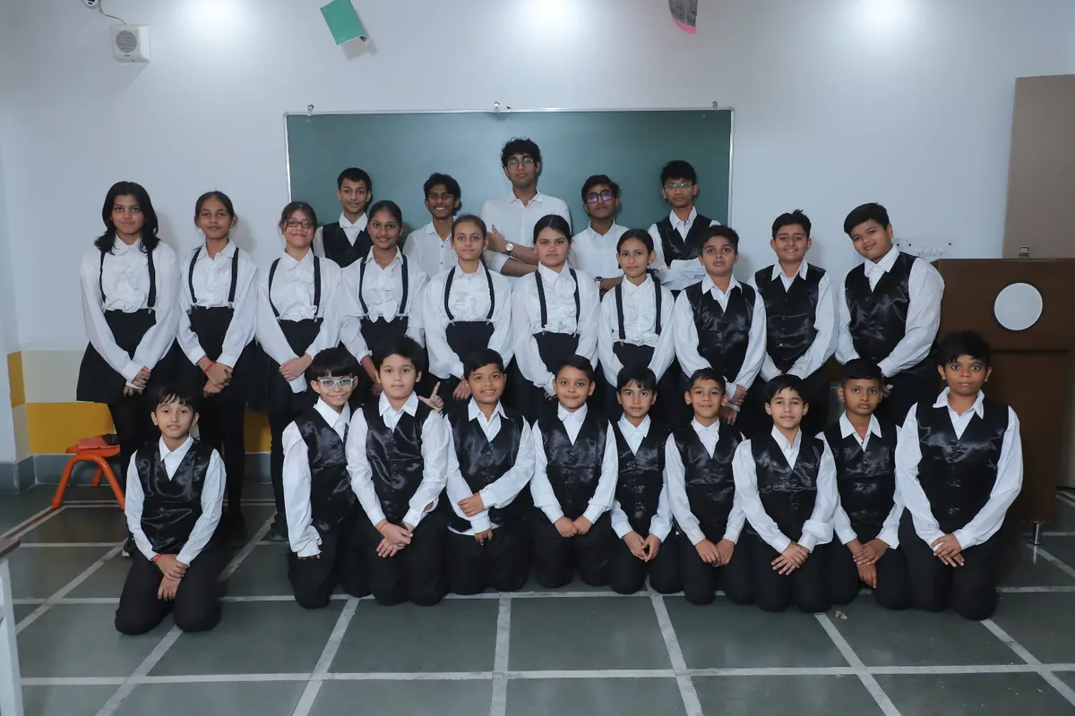 Senior students in formal Annual Day outfits with their teachers at SKS World School, Greater Noida West