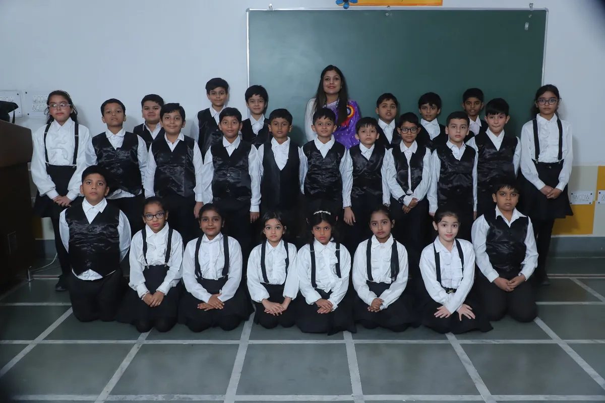 Class group photo in black-and-white Annual Day outfits at SKS World School, Greater Noida West