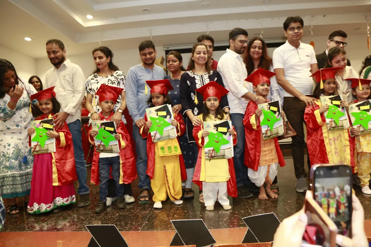 Kindergarten graduates in caps and gowns with their parents at SKS World School, Greater Noida West