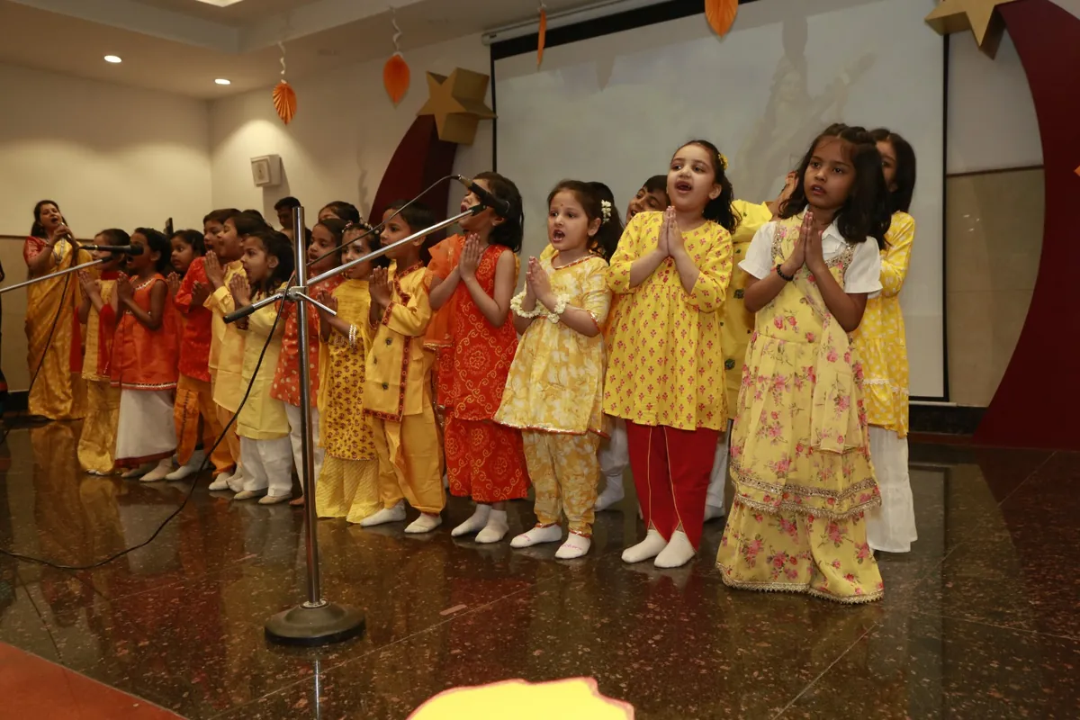 Kindergarten children performing on stage in festive outfits at SKS World School, Greater Noida West