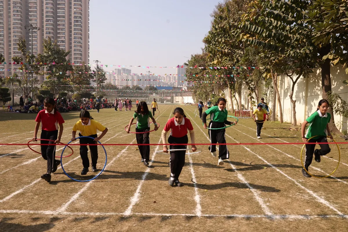 Hoop race in progress on the sports ground at SKS World School, Greater Noida West